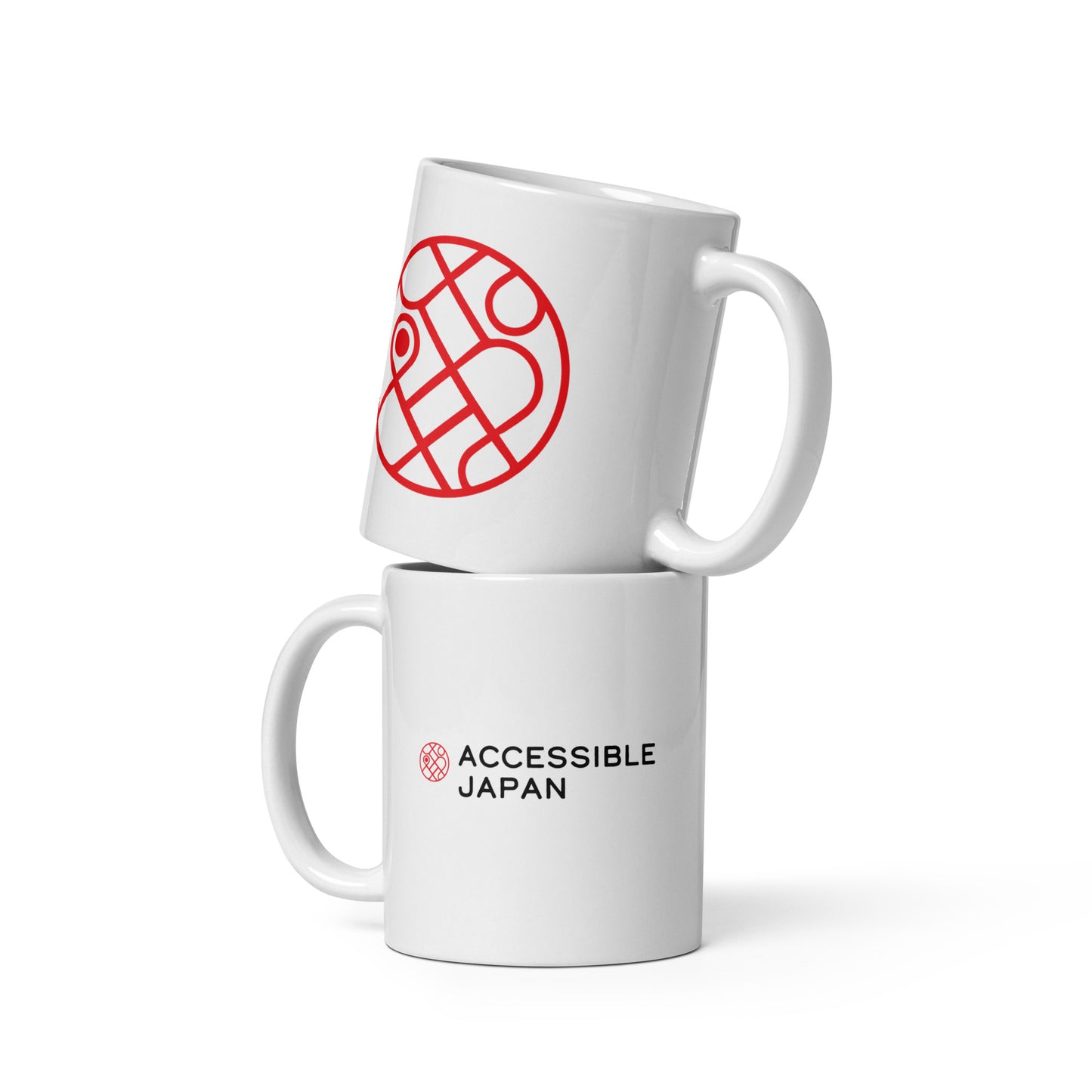 Two white mugs stacked. The top mug displays a large red circular logo, and the bottom mug features the "Accessible Japan" logo and text.