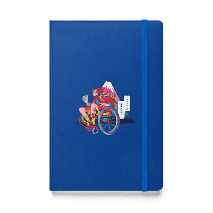 A blue notebook features an illustration of a person in a wheelchair holding a map, with Mount Fuji in the background.