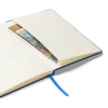 An open notebook showing an inner pocket containing papers, with a blue ribbon bookmark hanging out.